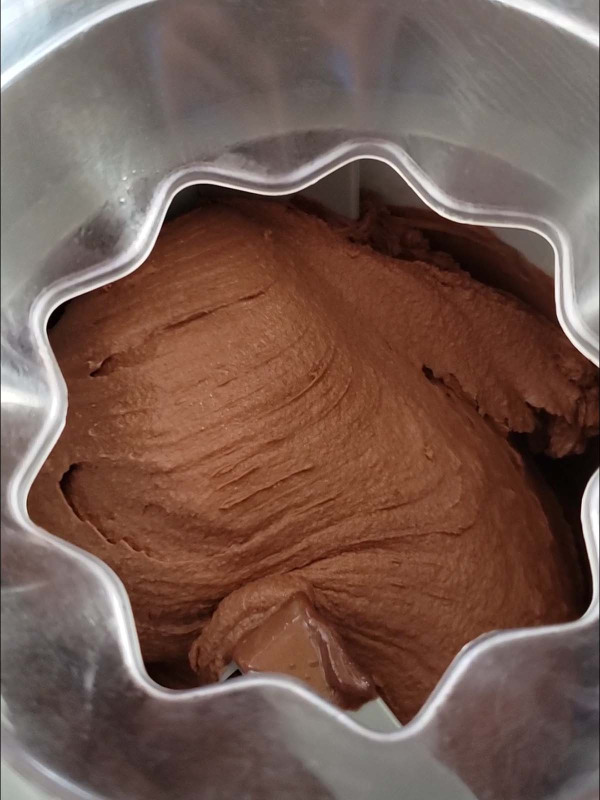 Chocolate ice cream churning in an ice cream maker.
