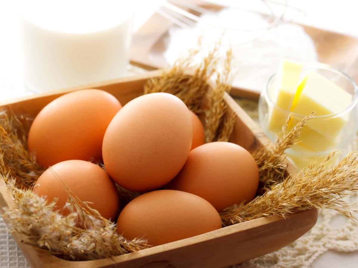 Brown eggs in a wooden bowl.