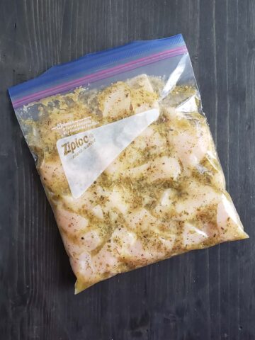Chicken and marinade in a ziplock bag.
