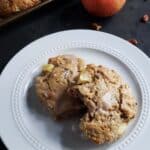 Two apple pecan scones on a white plate.