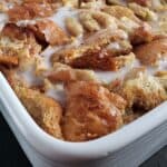 Close up of condensed milk bread pudding in a white baking dish.