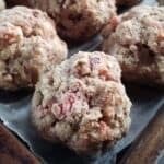 Frozen meatballs on a sheet pan.