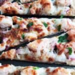 Shrimp scampi flatbread pizza closeup.