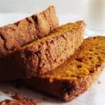 Three slices of sourdough pumpkin bread on a white plate.