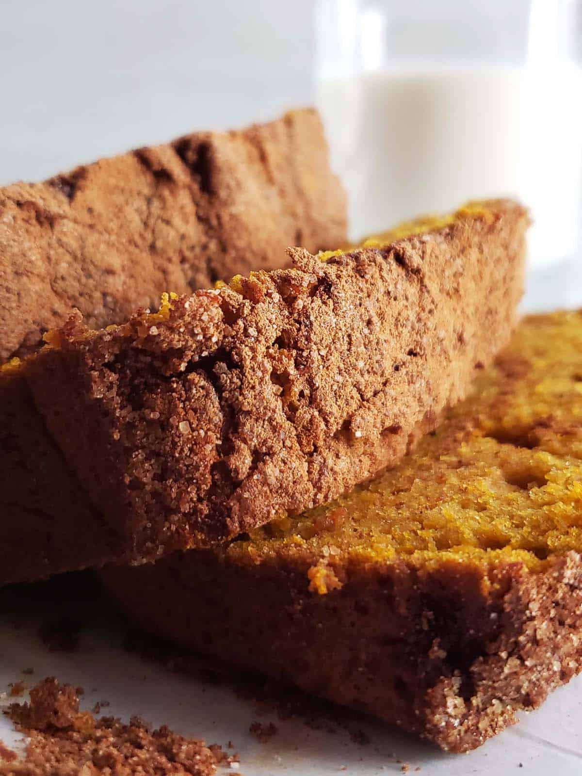 Three slices of sourdough pumpkin bread on a white plate.