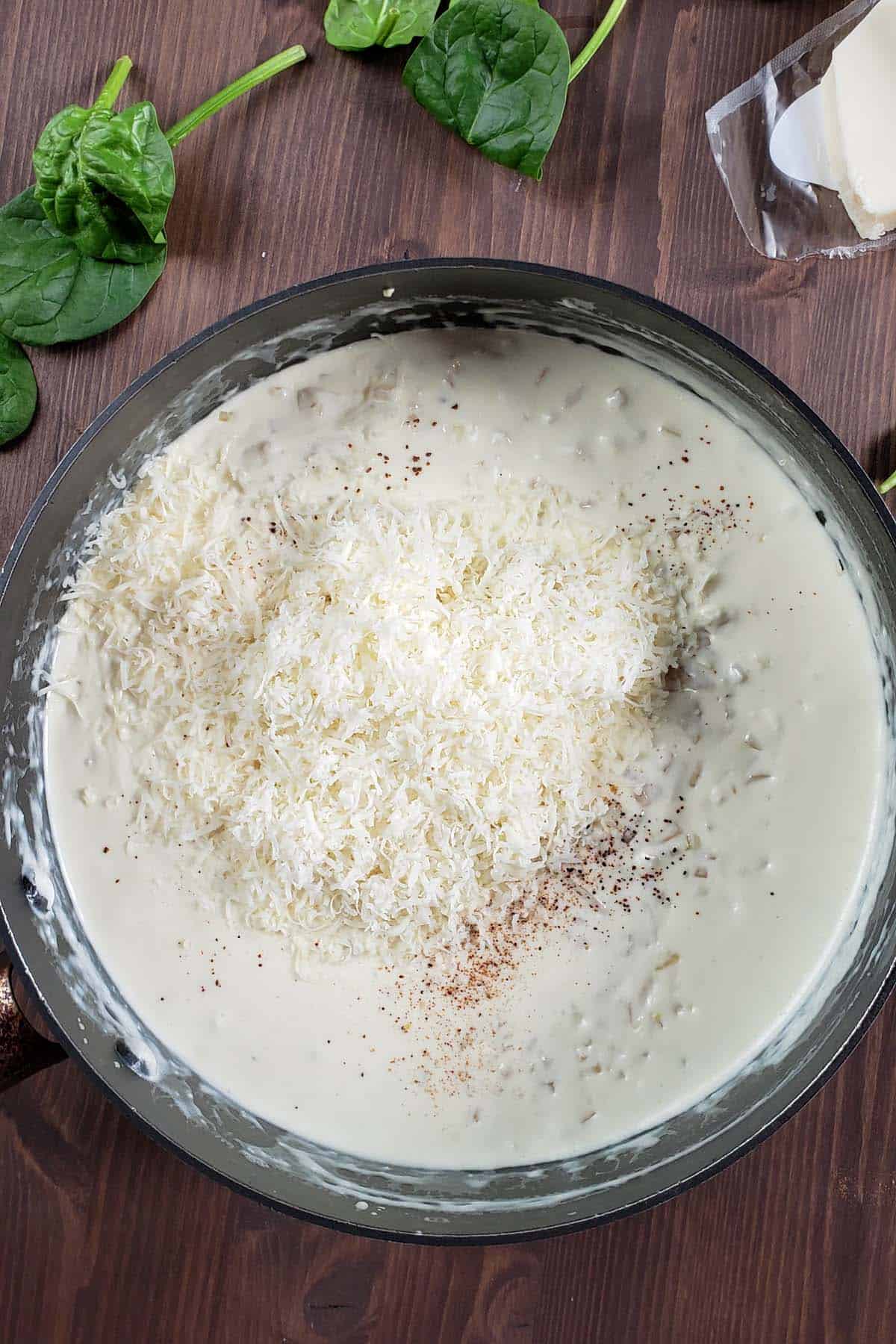 Asiago cheese sauce in a sauce pan.