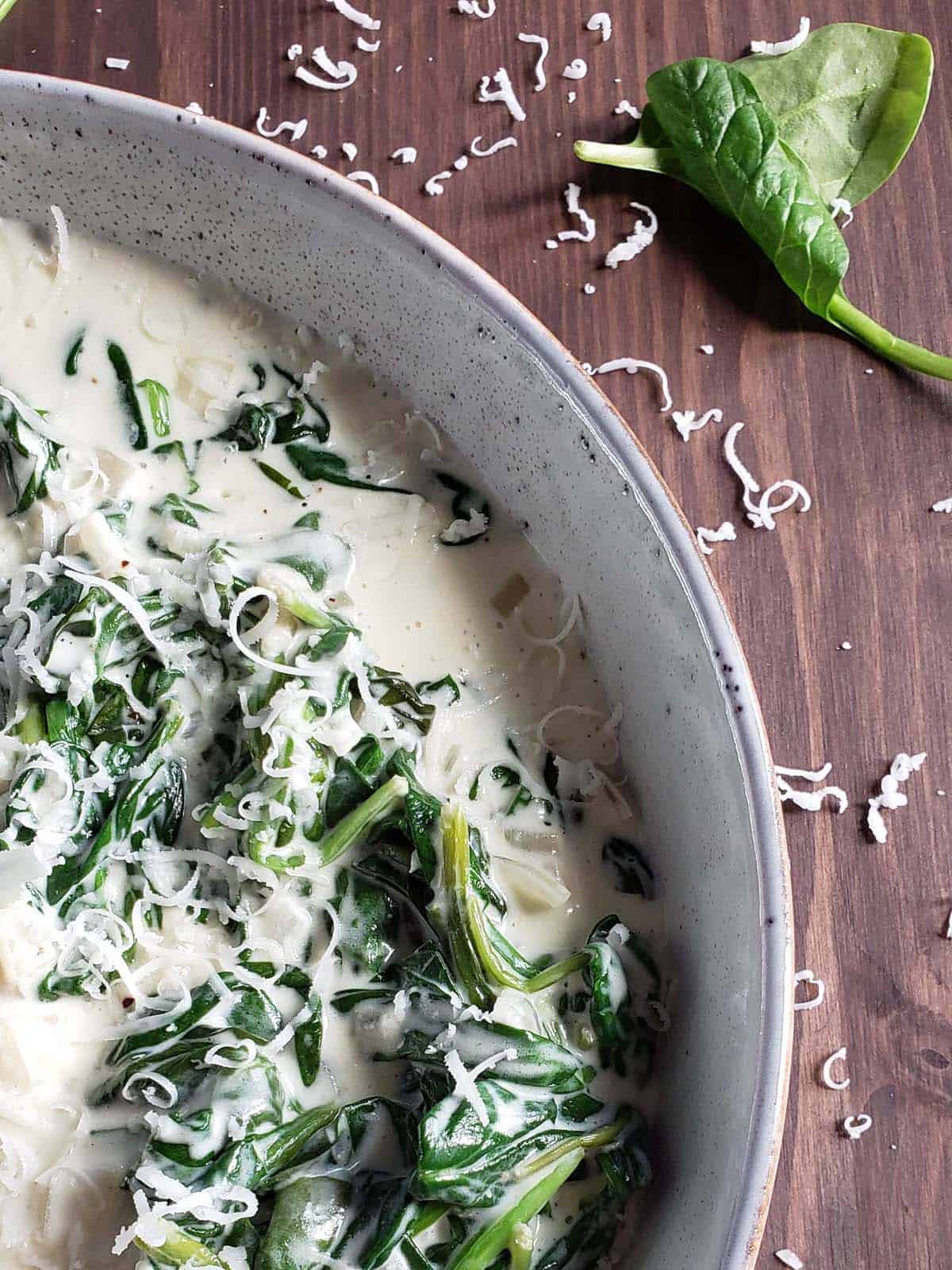 Asiago creamed spinach in a light colored bowl.