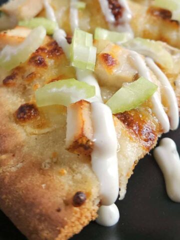 Close up of a slice of buffalo chicken pizza.