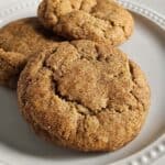 Three snickerdoodles on a white plate.