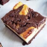 Single Nutella Cheesecake Brownie on a white plate.
