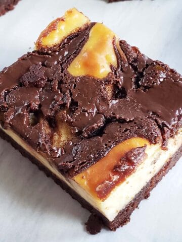 Single Nutella Cheesecake Brownie on a white plate.
