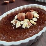 Nutella creme brulee in a white ramekin topped with chopped hazelnuts.