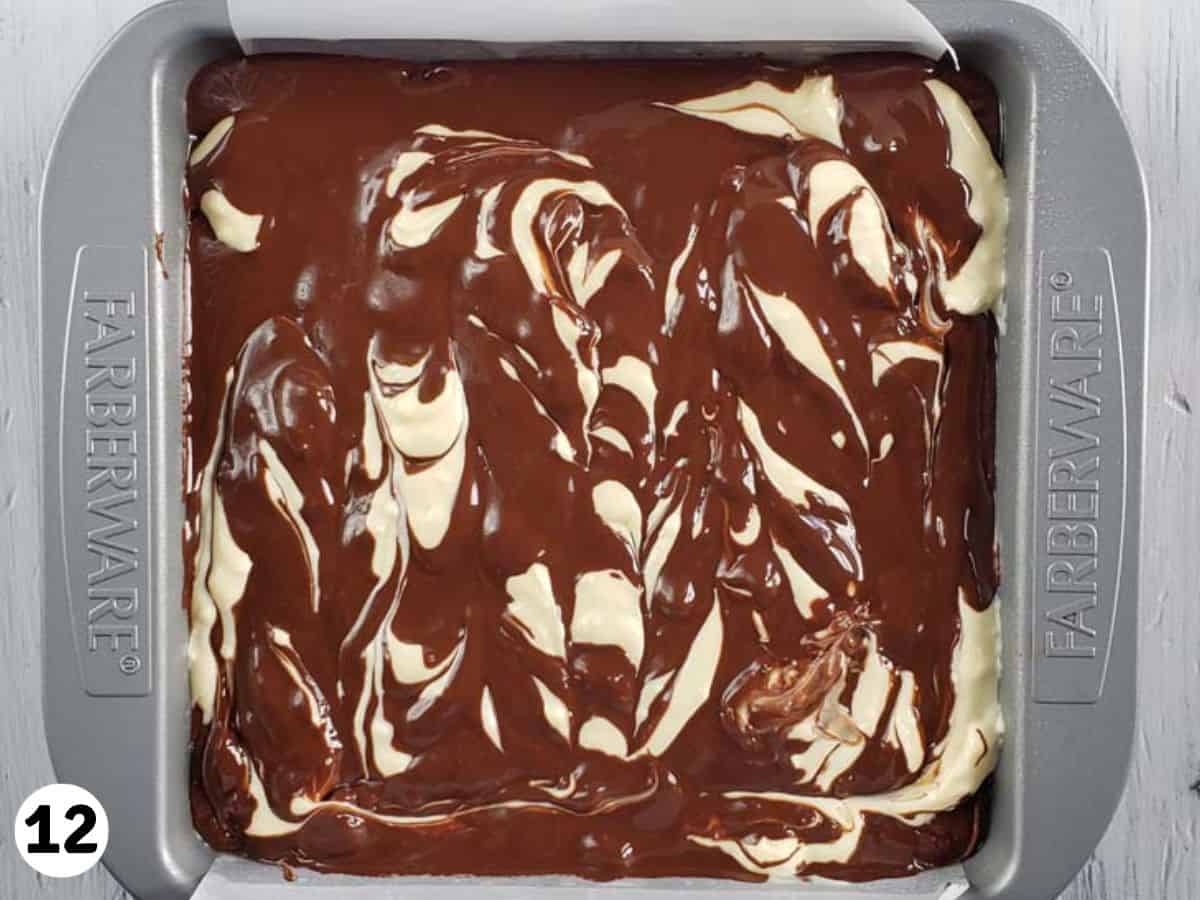 Nutella brownies with a cream cheese swirl in a metal baking pan.