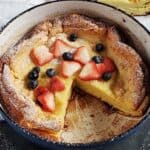 Sourdough dutch baby topped with berries.