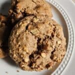 Pile of sourdough apple cookies on a white plate.