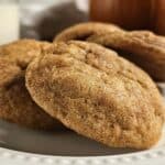 Close up of five sourdough pumpkin spice cookies on a white plate.