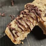 Close up of a shortbread bar drizzled with chocolate.