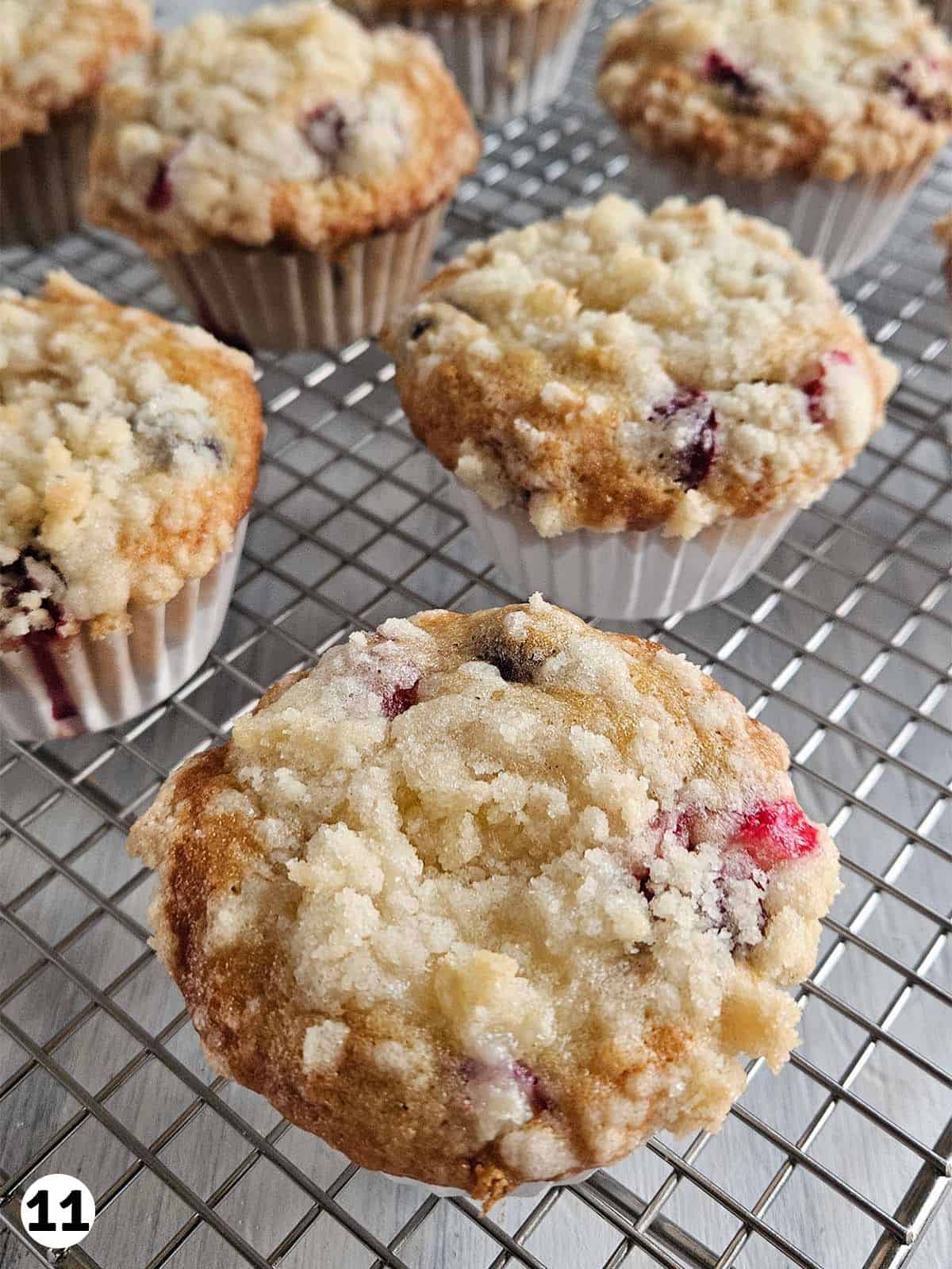 Sourdough cranberry muffins on a wire rack.