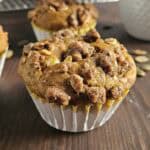 Pumpkin muffin on a dark wood surface.
