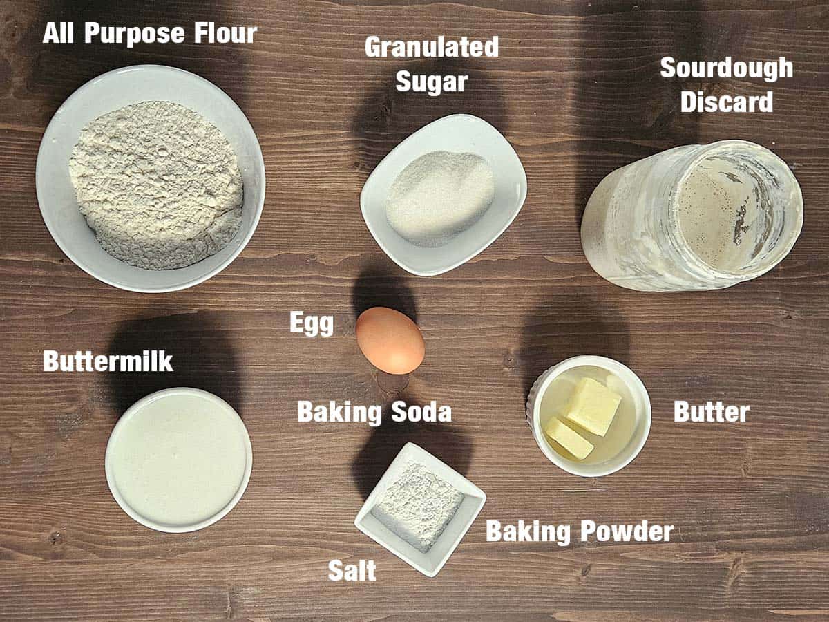 Sourdough pancake ingredients on a dark wood surface.