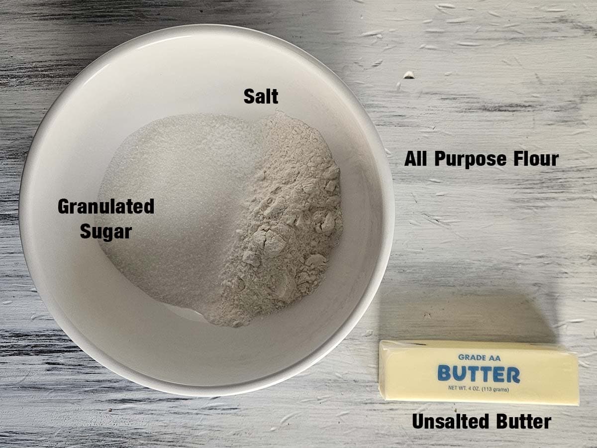 Streusel ingredients on a white wood surface.