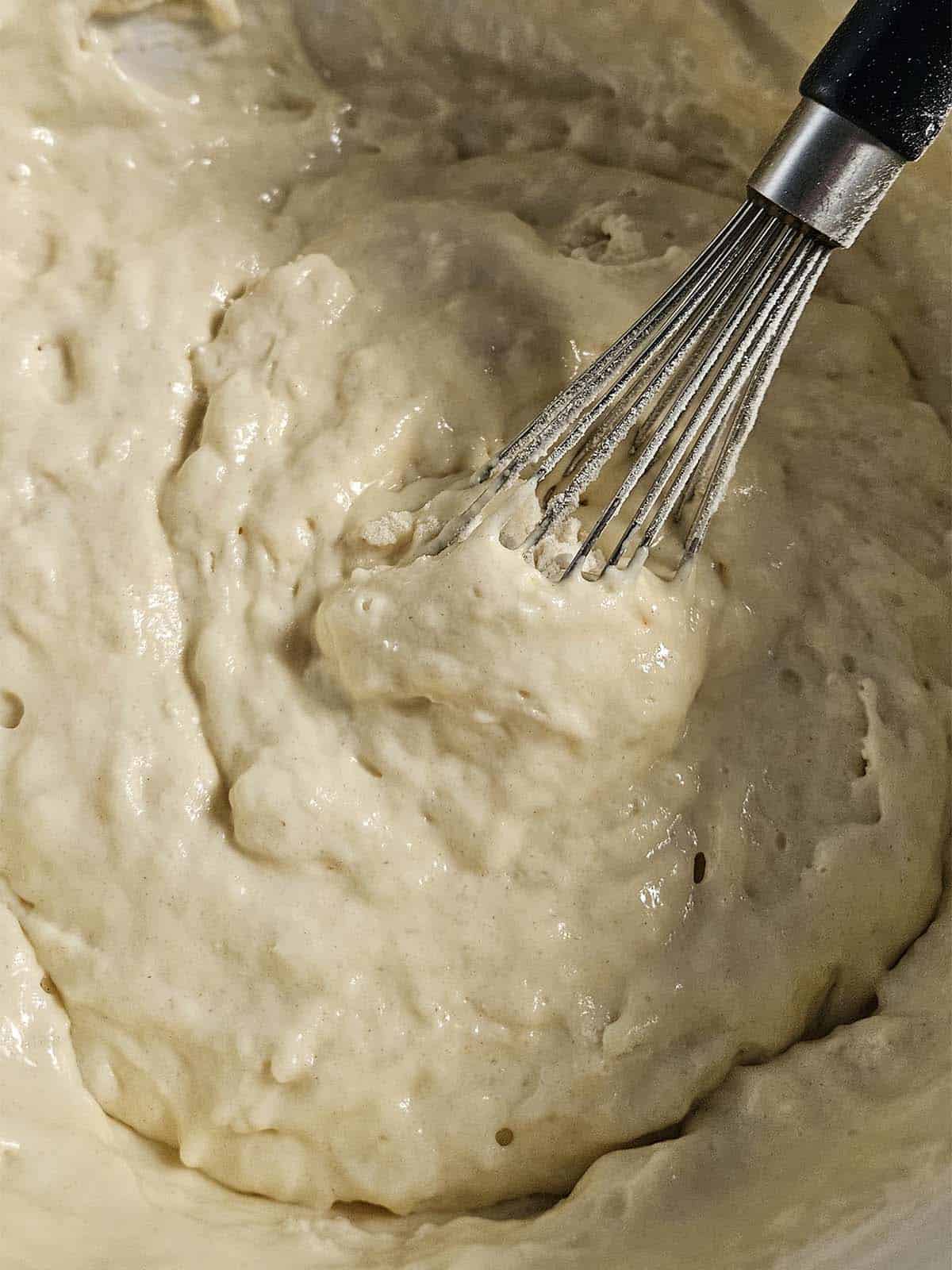 Pancake batter in a white bowl.