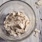 Dried sourdough flakes in a glass jar.