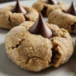 Peanut butter blossom cookie on a white plate.