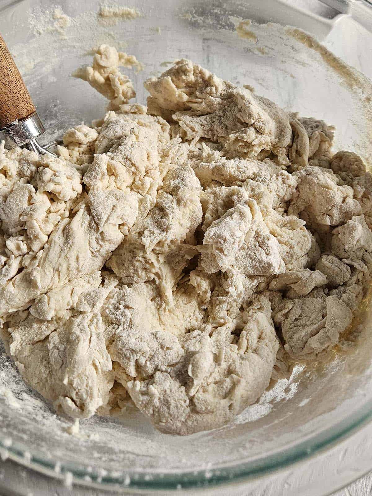 Flour and water roughly stirred together in a glass bowl.