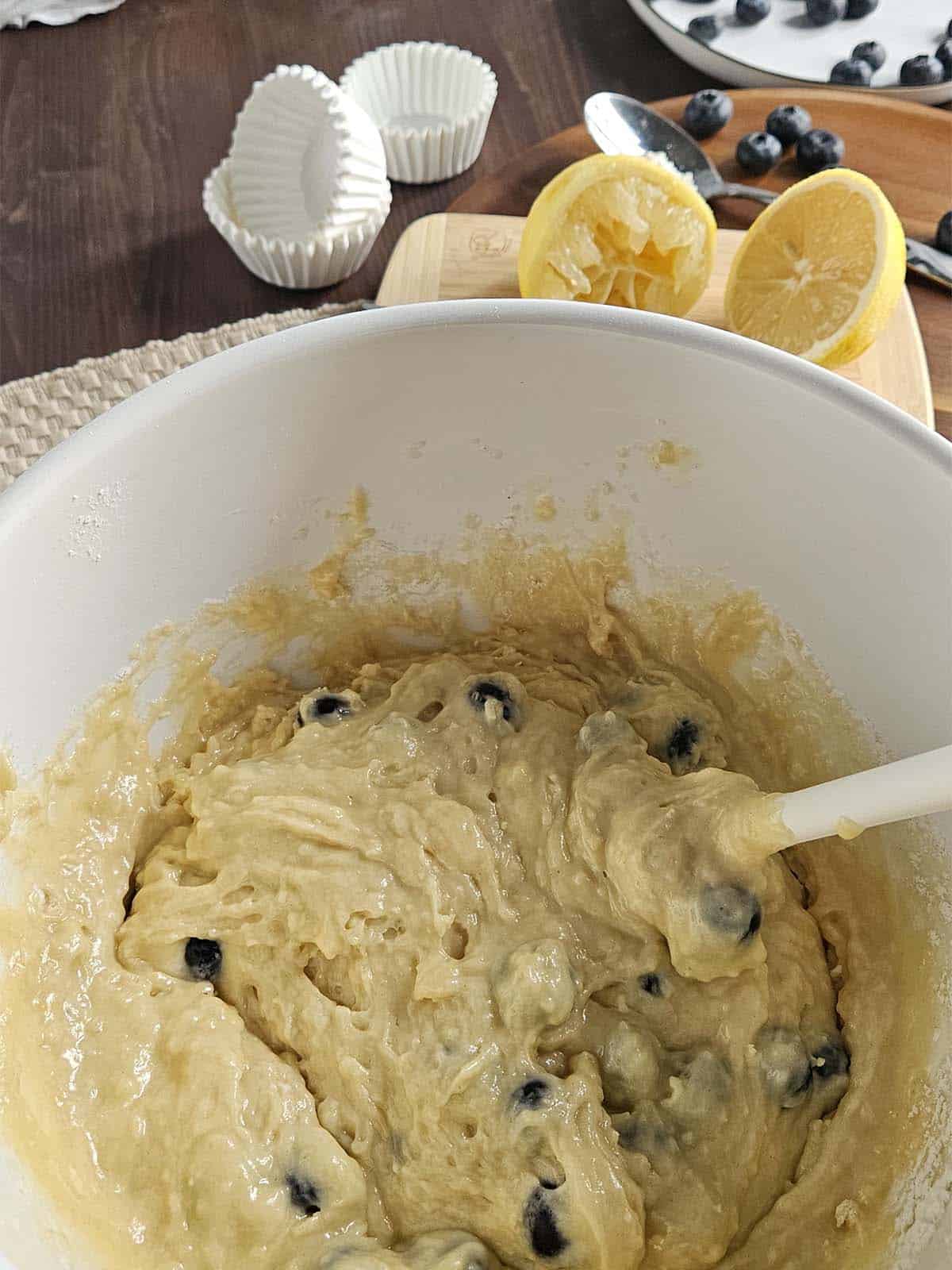 Blueberry muffin batter in a white bowl.