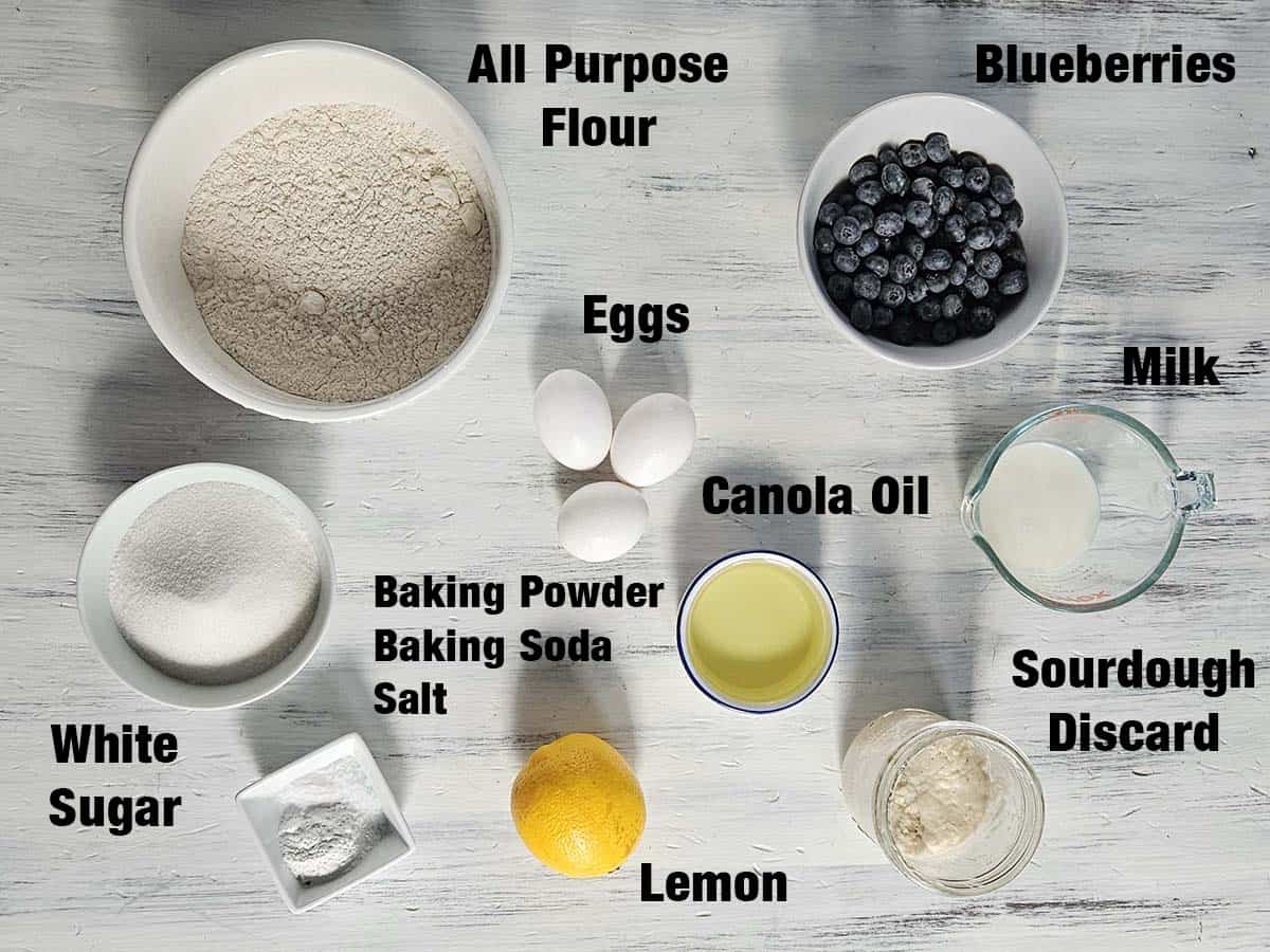 Sourdough blueberry muffin ingredients on a white board.